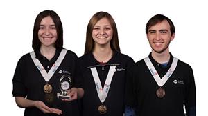 Three winning students pose with medals 